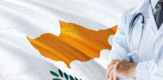 Cypriot Doctor standing with stethoscope on Cyprus flag background. National healthcare system concept, medical theme.
