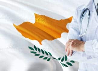 Cypriot Doctor standing with stethoscope on Cyprus flag background. National healthcare system concept, medical theme.