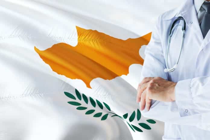 Cypriot Doctor standing with stethoscope on Cyprus flag background. National healthcare system concept, medical theme. Cypriot Doctor standing with stethoscope on Cyprus flag background. National healthcare system concept, medical theme.