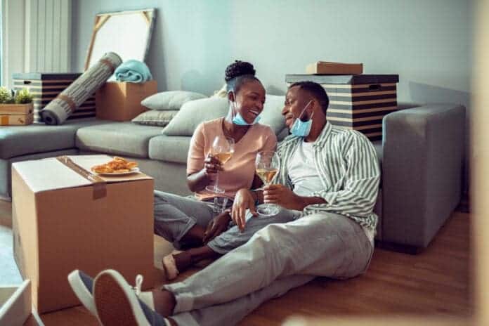 Young couple celebrating moving to their new home