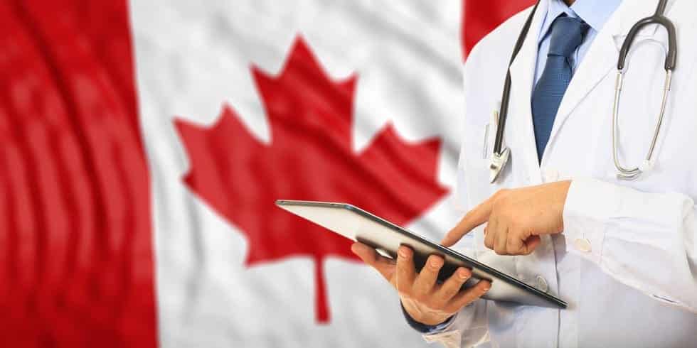 Doctor on Canada flag background - Canadian Healthcare