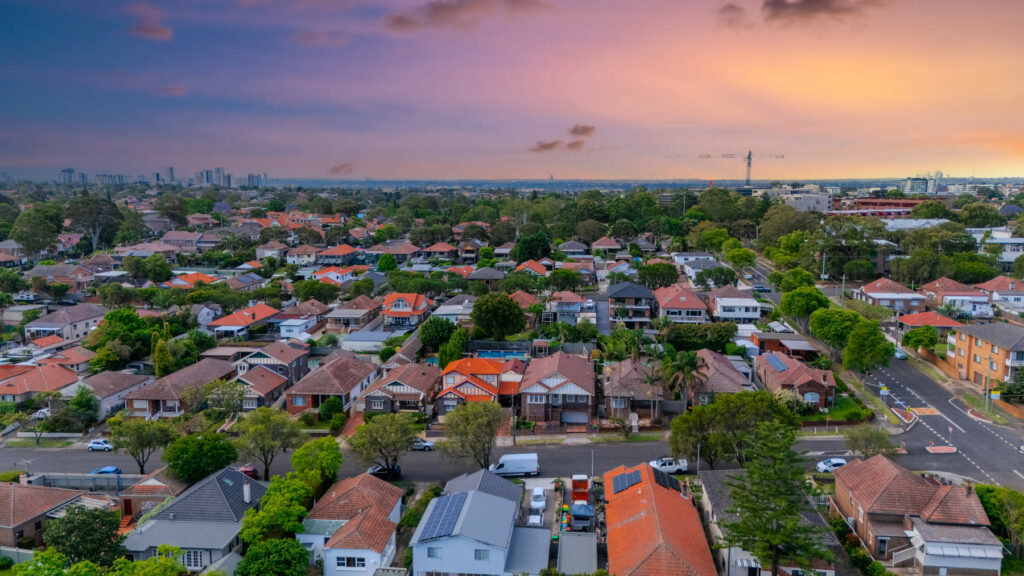 Panorama Sunset aerial drone view of western Sydney Suburbs of Canterbury, Burwood, Ashfield Marrickville, with houses, roads and parks in Sydney, New South Wales