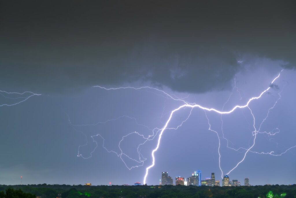 Dramatic lightning storm over the Dallas skyline, representing the city’s exposure to extreme weather conditions.