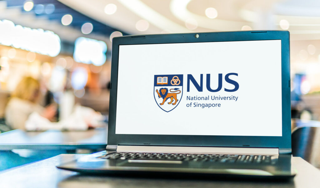 Laptop displaying the logo of the National University of Singapore (NUS), representing higher education opportunities in Singapore.