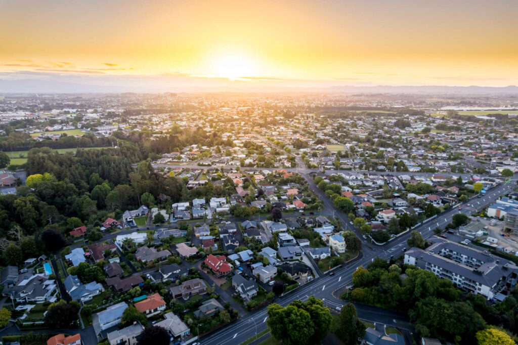 Aerial drone view at sunset, looking towards Hamilton West, over the city of Hamilton (Kirikiriroa) in the Waikato region of New Zealand.