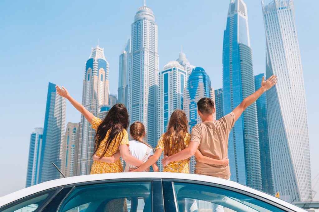 Family in front of Dubai skyline - pros and cons of living abroad