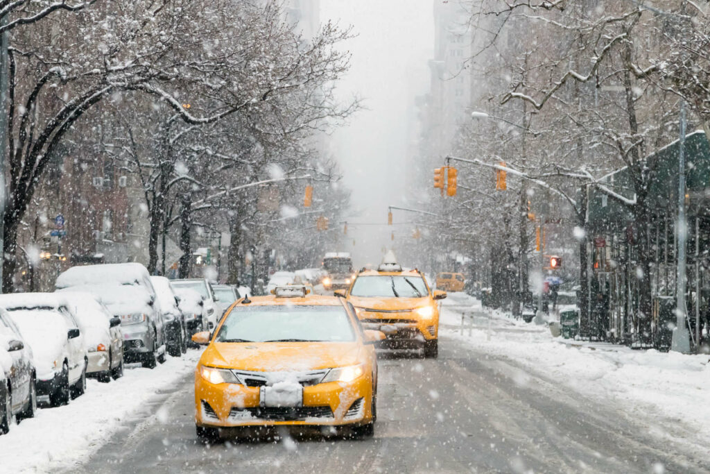 Taxis drive down a snow covered 5th Avenue during a winter in Manhattan, New York City