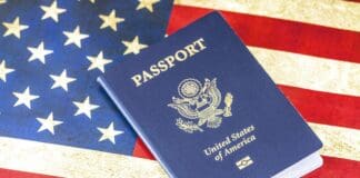 An image of a US Passport with the American Flag in the Background - Immigrating to the USA - How to Immigrate to the USA