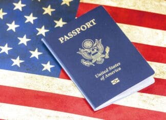 An image of a US Passport with the American Flag in the Background - Immigrating to the USA - How to Immigrate to the USA