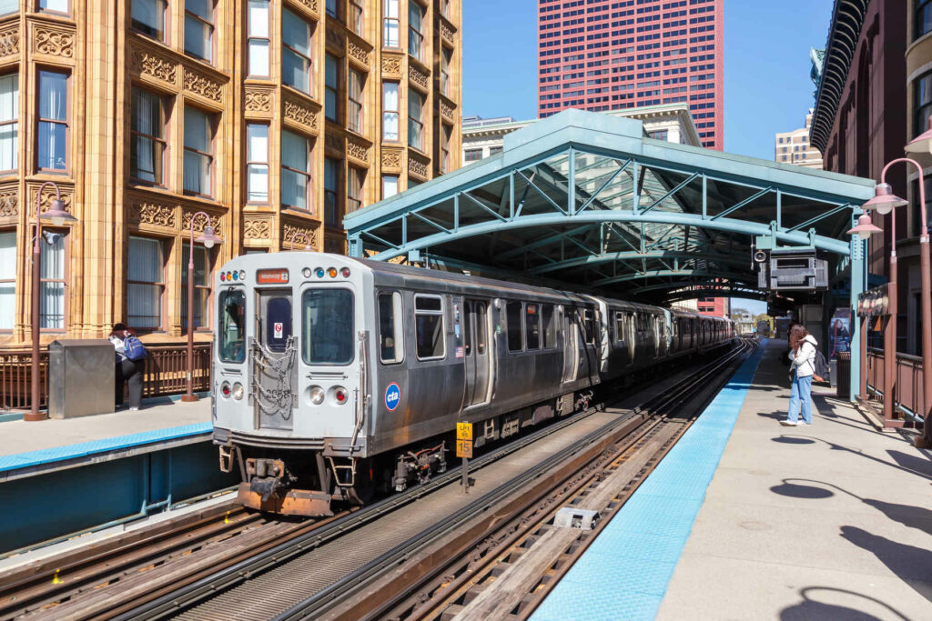 Chicago 'L' train at an elevated downtown station, highlighting the city’s extensive public transport system.